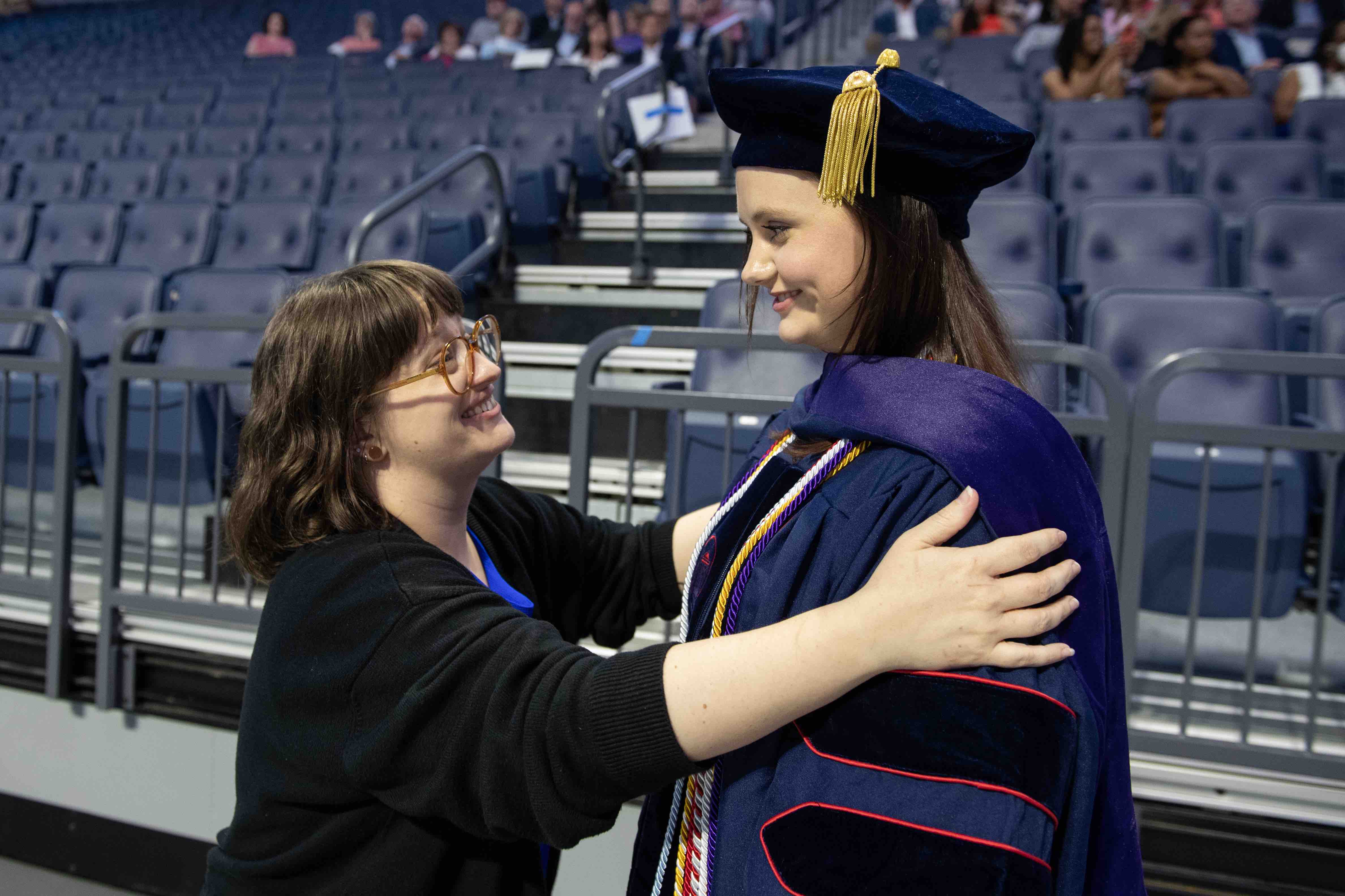 staff member and student at graduation