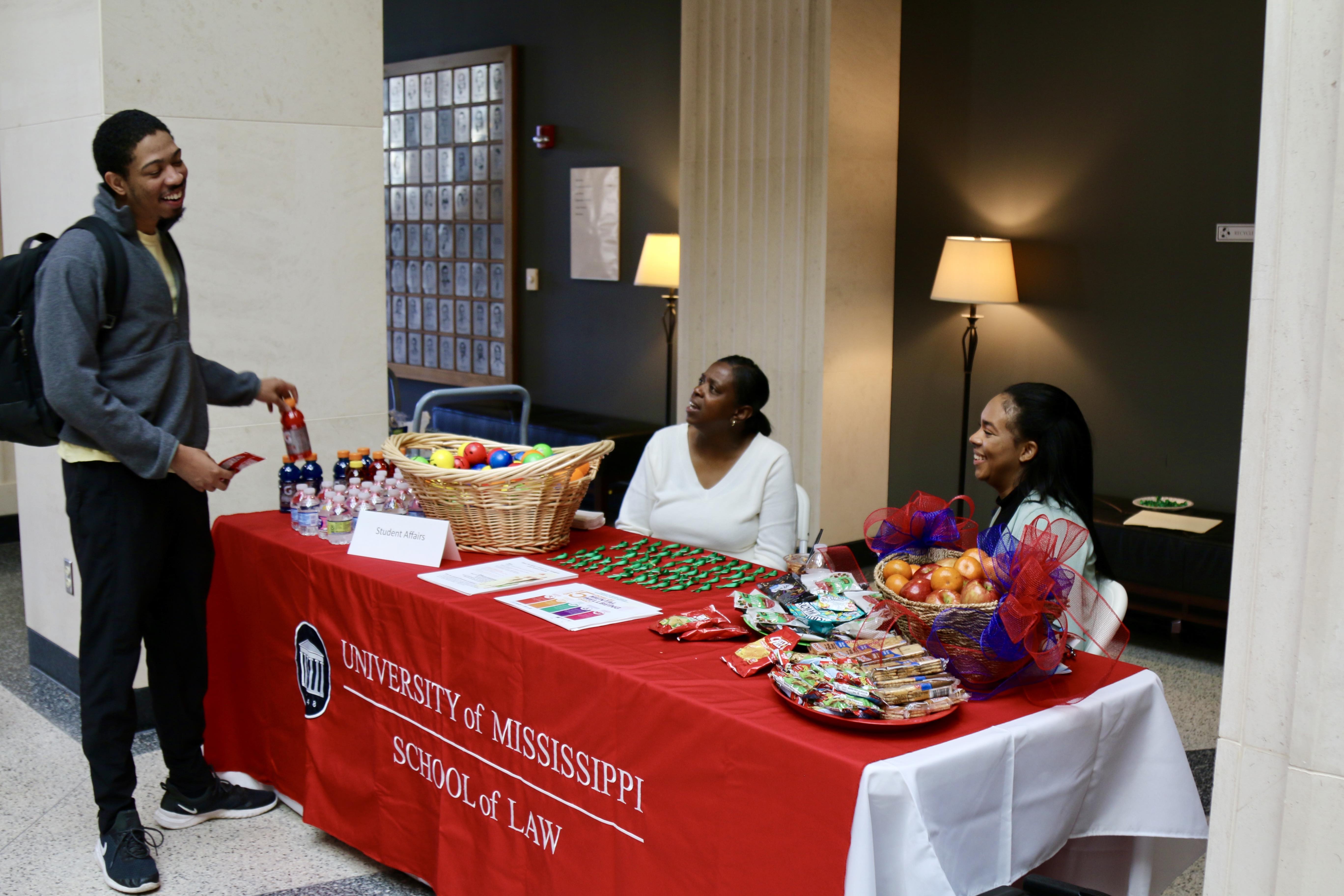 student speaking with law staff 