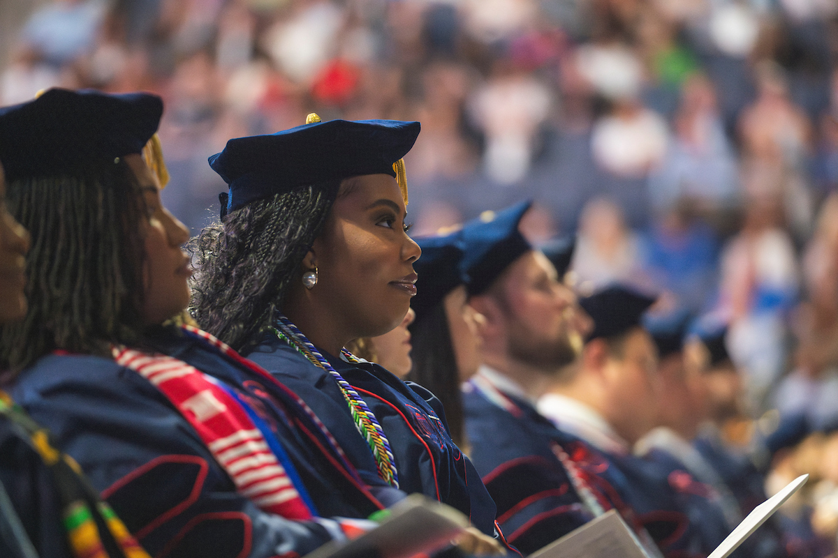 graduates sitting at graduation