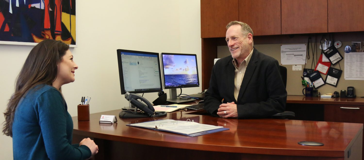 UM Law Registrar Eddie Upton speaks with third-year law student Brittney Eakins in his office.