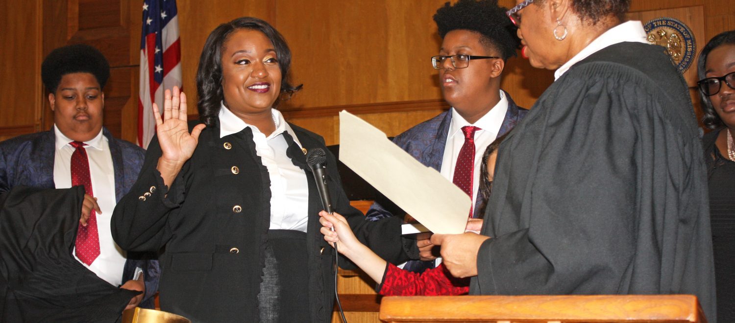 Crystal Wise Martin, left, is sworn in by her mother, Patricia Wise.