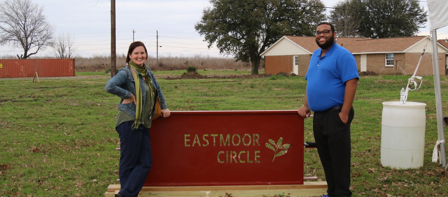 Housing Clinic Director Desiree Hensley and law student Brandon Wilson stand with the Eastmoor Circle sign.